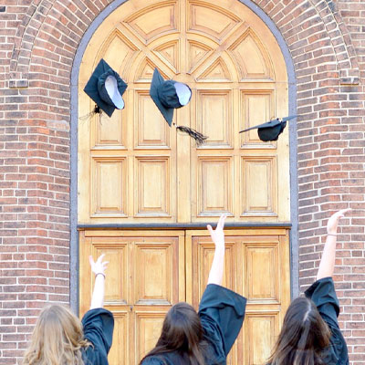 Graduates throwing caps in the air